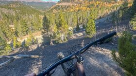 View from someone on a mountain bike looking down a trail.
