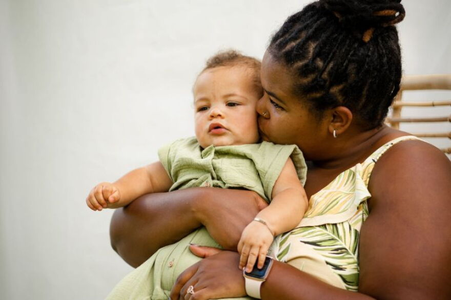 A mother hugs her infant