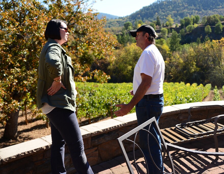 Oregon Department of Agriculture Director Alexis Taylor speaks with Rogue Valley Winegrowers president John Pratt about smoke taint's effects on wine grape crops.