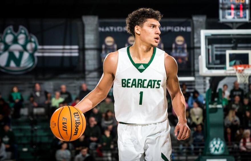 Action shot of Diego Bernard vs Newman basketball