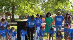 Kids gather with Lexington officials for the ground breaking of a new outdoor play and education area at the Lexington Family Care Center