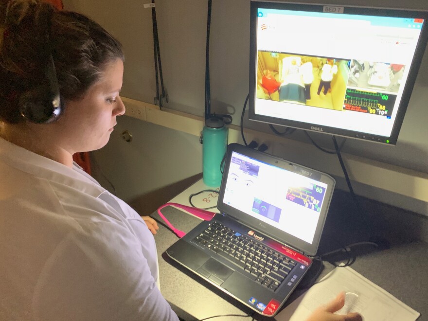 Belmont adjunct nursing instructor Morgan Bryant mimics the "death rattle" in her headset, also controlling the pulse, breathing and blood pressure of the simulated patients in the lab.
