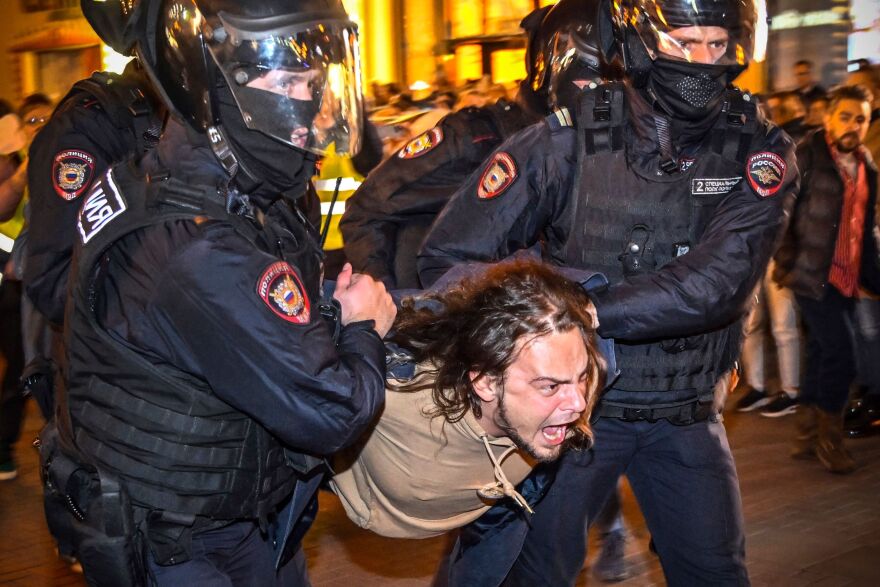 Police detain a man during protests against Russia's military mobilization in Moscow on Wednesday. More than 1,300 people have been arrested at demonstrations across Russia against President Vladimir Putin's announcement of a partial mobilization of civilians to fight in Ukraine, a police monitoring group said on Wednesday.