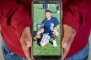 A photograph of a Victor man detained by ICE earlier this month is held by the man's wife in their Teton Valley home.