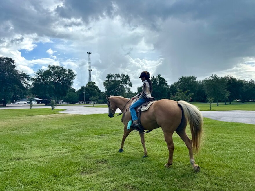 Nayela Hedrick Joshi rides her horse, Cruise, around the grounds before entering the arena for the PacWest Barrel Racing event Friday. “I got my first pony when she was 6 months old,” Hedrick Joshi said.