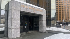 Stone building entrance with gold letters that say "Fifth Avenue Building."