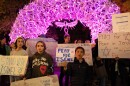 Children hold up signs saying "Pray for Israel" in front of the antler arch at Jackson Town Square. They were among the around 70 residents who came out to support Israel Monday night.