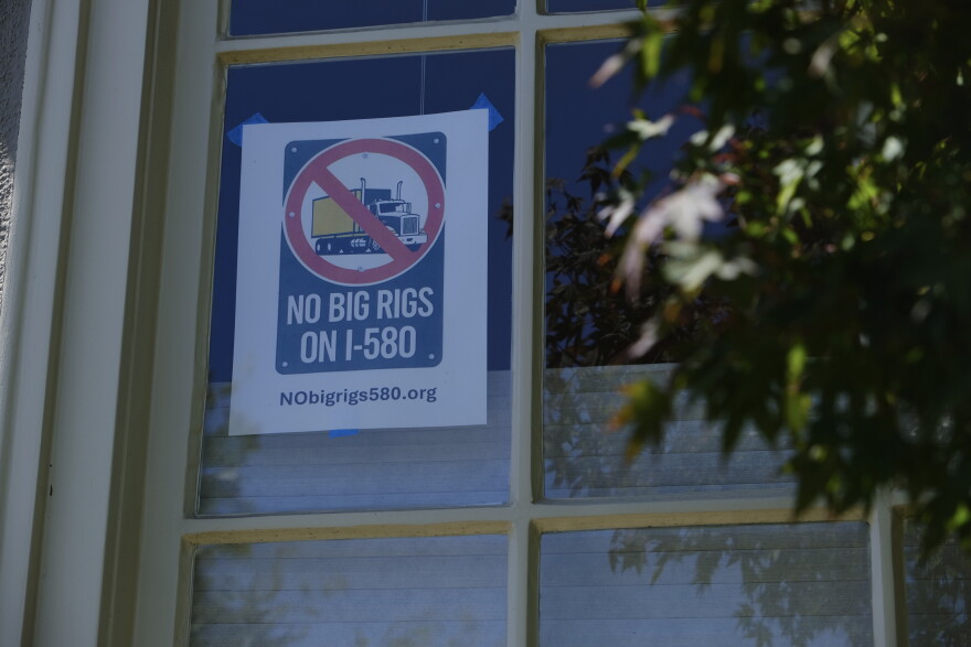 A “NO BIG RIGS ON I-580” poster hangs in the front window of Susan Gallardo’s home in Oakland’s Crocker Highlands neighborhood.
