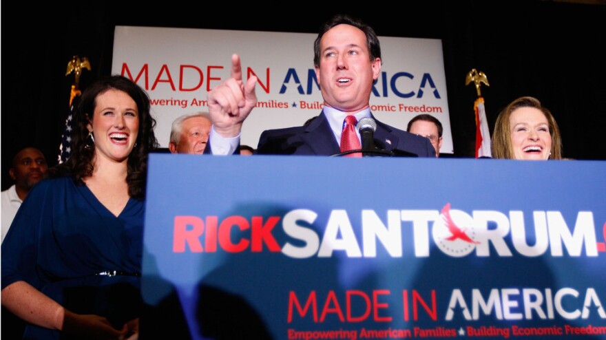 Republican presidential hopeful and former U.S. Sen. Rick Santorum speaks to supporters, flanked by his daughter, Elizabeth (left), and wife, Karen.