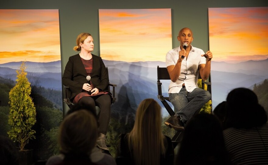 photo of two people presenting on a conference panel