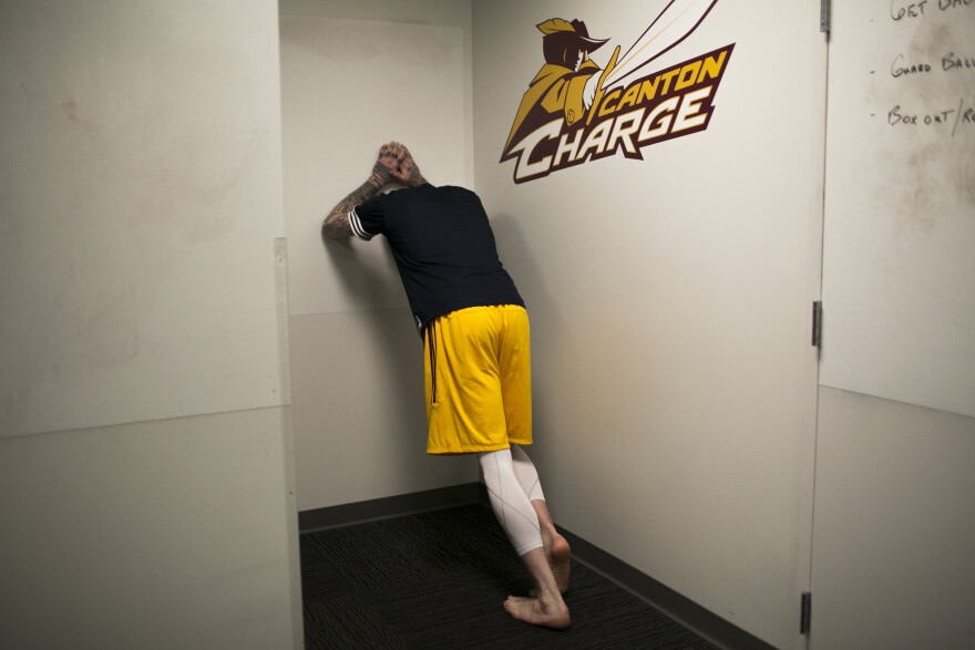 Minnerath stretches in the locker room of the Canton Memorial Civic Center before a game against the Iowa Energy on Feb. 16. A family friend, and a coach willing to take a chance on Minnerath, gave him a second shot at a basketball career.