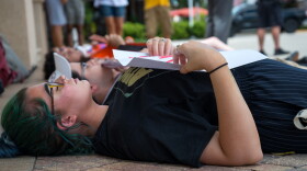 Southwest Florida students lie down on the sidewalk outside of the Wells Fargo branch on 5th Avenue South in downtown Naples.