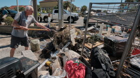 A resident of a storm damaged apartment complex unloads his shovel on a pile of trash while cleaning out his apartment in Pensacola Beach, Florida USA several days after the landfall of Hurricane Isaias on October 11, 2026.