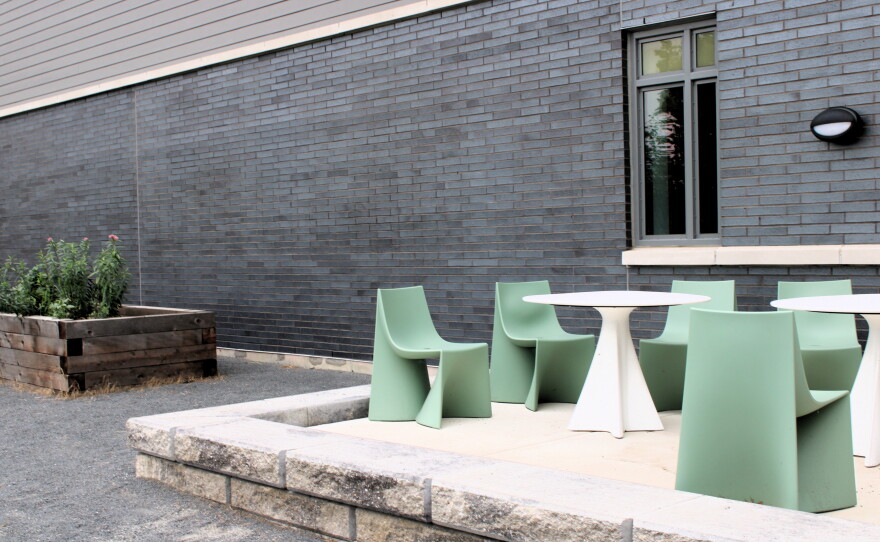 The recreation yard at Monarch Youth Center includes lounge areas and garden beds, which Micah helps tend.
