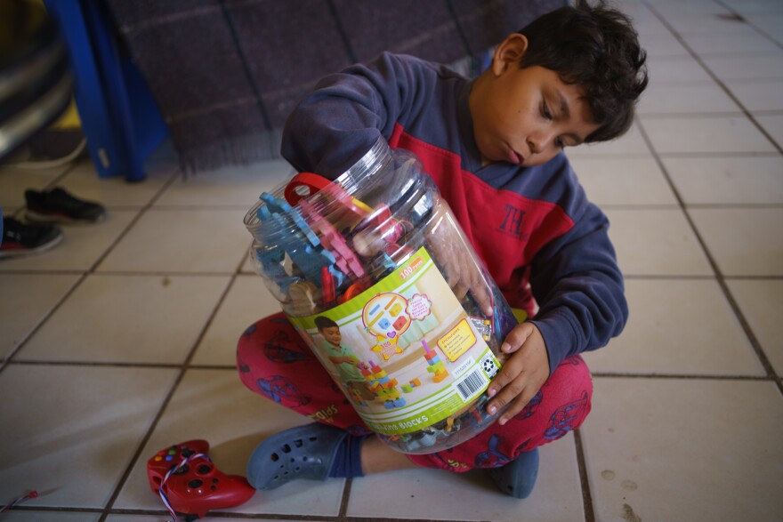 Donovan digs through his collection of secondhand toys at Pan de Vida Migrant Shelter in Ciudad Juárez on September, 10, 2020.