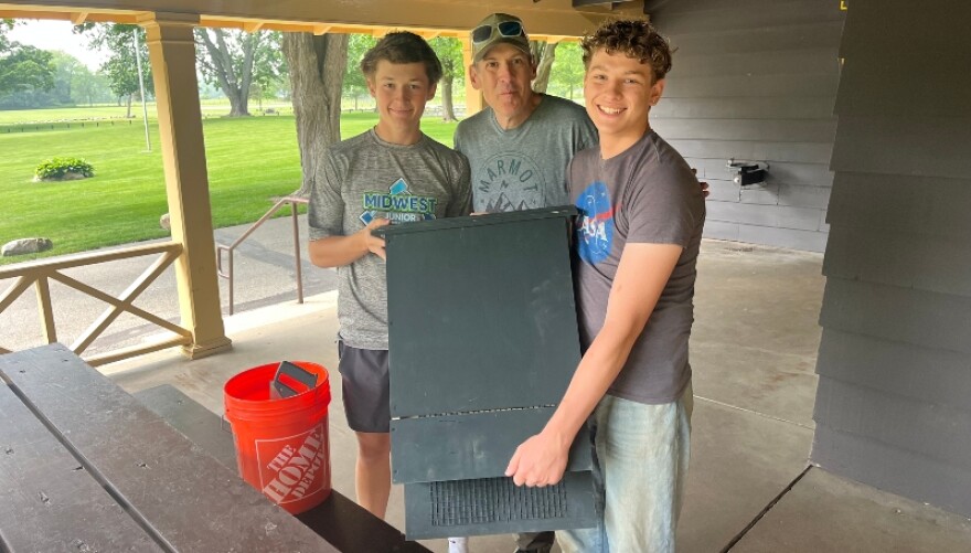 Samuel Konyndyk (left) holds bat box at Fallasburg Park