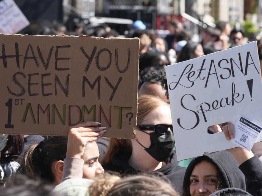 Students carrying signs on April 18, 2024 on the campus of USC protest a canceled commencement speech by its 2024 valedictorian who has publicly supported Palestinians.