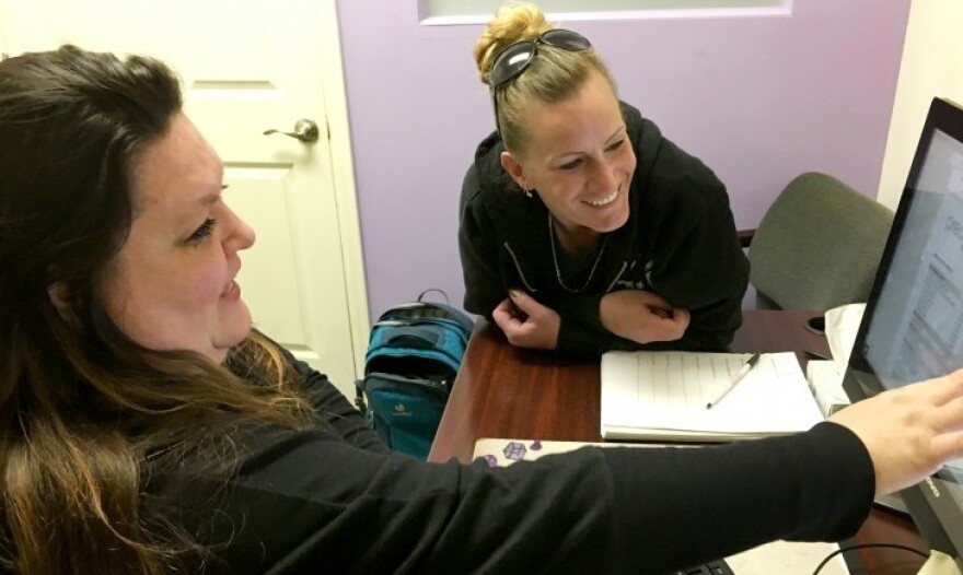 Counselor Melissa McConnell and patient Sara Florence look at a computer screen at the Denver Recovery Group, a treatment center.
