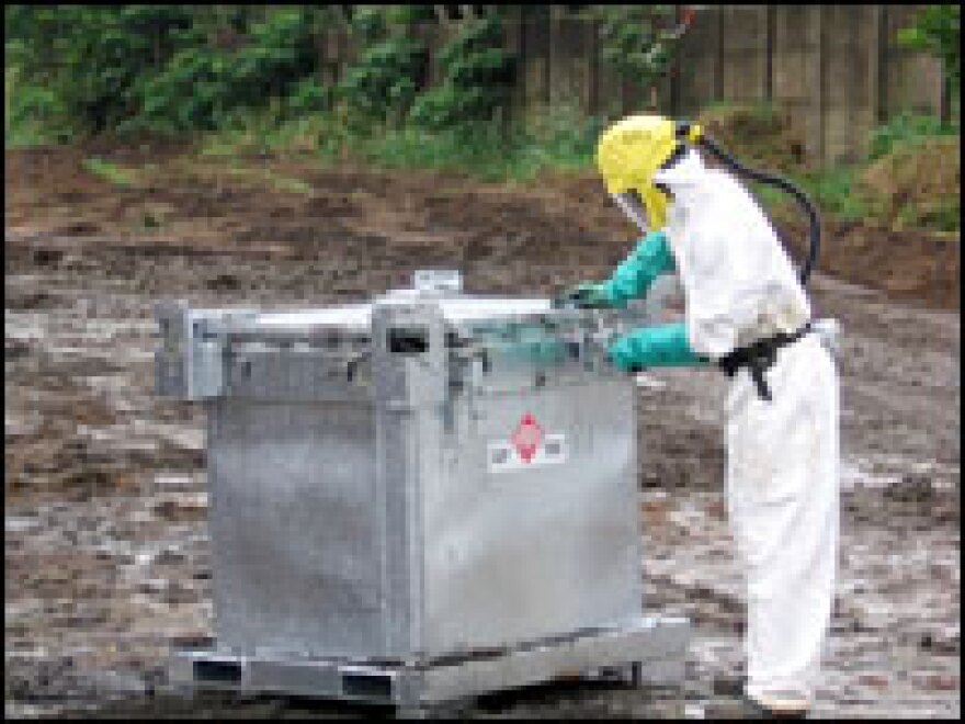 A worker for Tredi International, the French company hired to handle clean-up, seals a metal container recently filled with pitch-black toxic waste. The company has been processing the hazardous material in Abidjan since September.