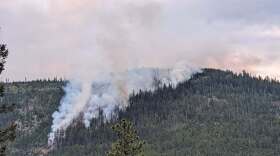 The Deer Fire is visible in the hills southeast of Missoula on the morning of July 19, 2025.