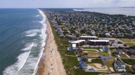 The Atlantic Ocean, beach and houses are at Duck, Outer Banks, North Carolina, on Thursday, August 24, 2023. (Photo courtesy of Ted Shaffrey, AP)