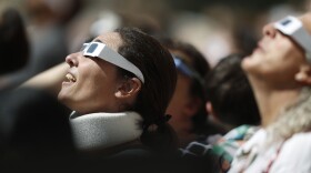 Wearing their solar eclipse glasses, residents react as they gather at the Denver Museum of Nature and Science to observe the peak moment of the partial solar eclipse as it passes over City Park in east Denver on Monday, Aug. 21, 2017. While only a partial eclipse in Denver--92 percent--other parts of the intermountain West experienced a total eclipse. The last time a total eclipse crossed the entire continental United States was June 8, 1918. (AP Photo/David Zalubowski)