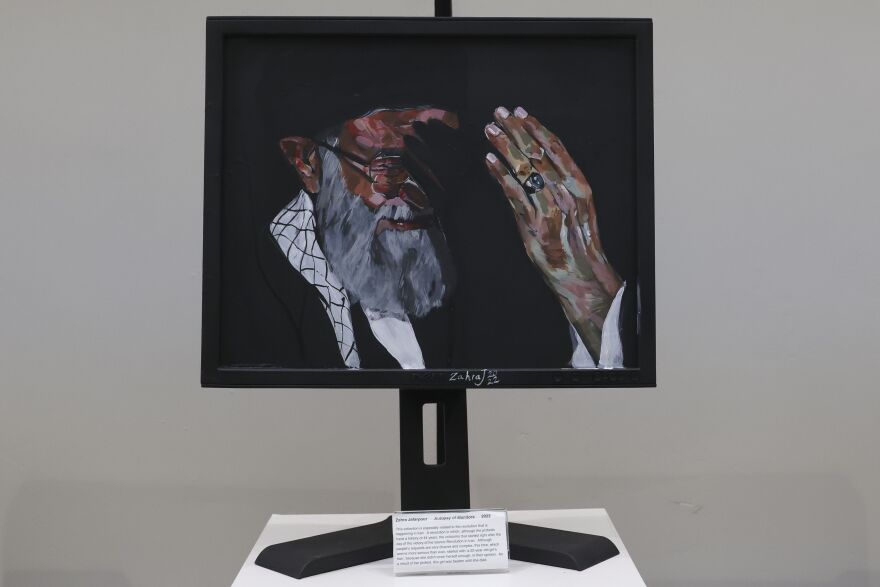 A Dell monitor with Ayatollah Ali Khamenei painted on it.
