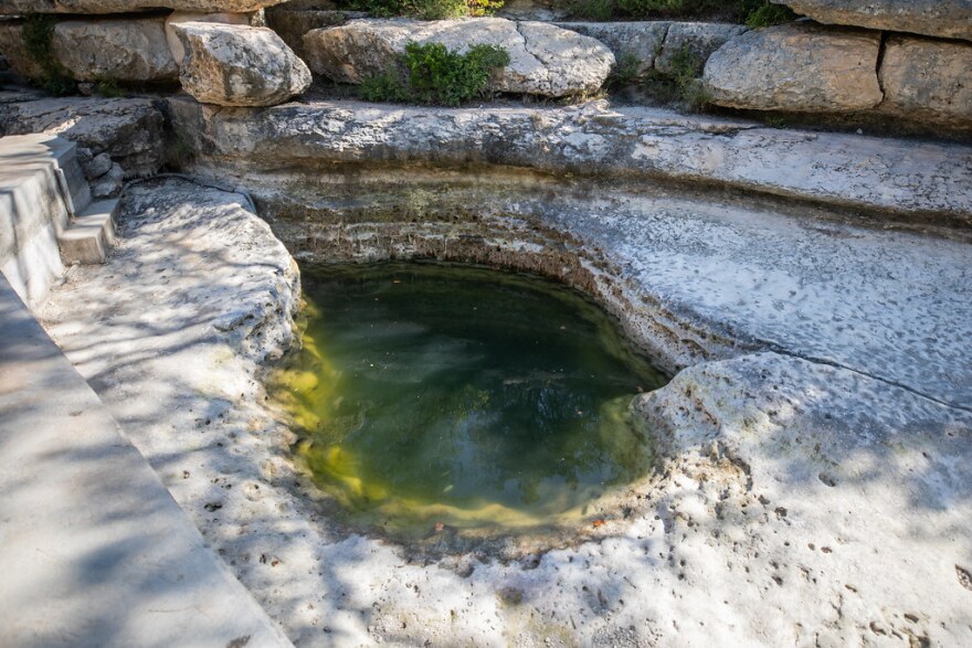 A small pool of water, about the size of a large hot tub, is the only remaining water currently in Jacob's Well.