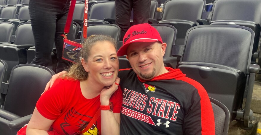 Two fans in ISU gear smile.
