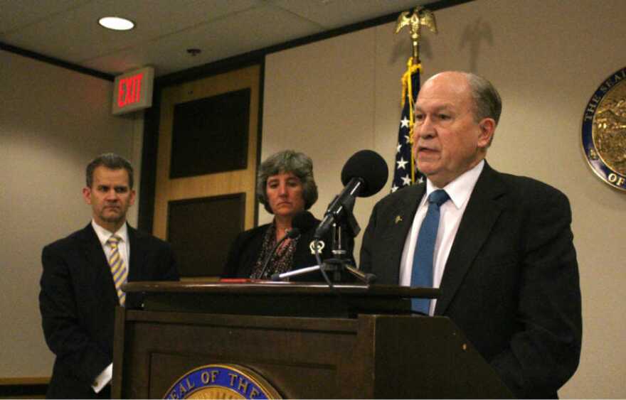 Alaska Gov. Bill Walker talks about his budget proposal in Anchorage on Friday as Revenue Commissioner Sheldon Fisher and budget director Pat Pitney look on. The budget for the fiscal year that begins in July 2018 would draw from Permanent Fund earnings. (Photo by Wesley Early/Alaska Public Media)