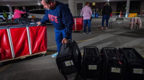 Harry Skene, Luzerne County Solicitor, loads voting machines as they come back to Penn Place in Wilkes-Barre on primary election night 2024.
