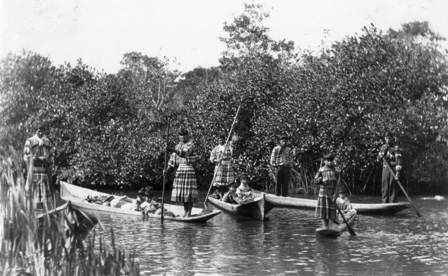 This image shows a Seminole family outing. Long, shallow, dugout canoes, that could be poled or paddled through the shallow waters of the Everglades, have been used by people for thousands of years, January 18, 1921.