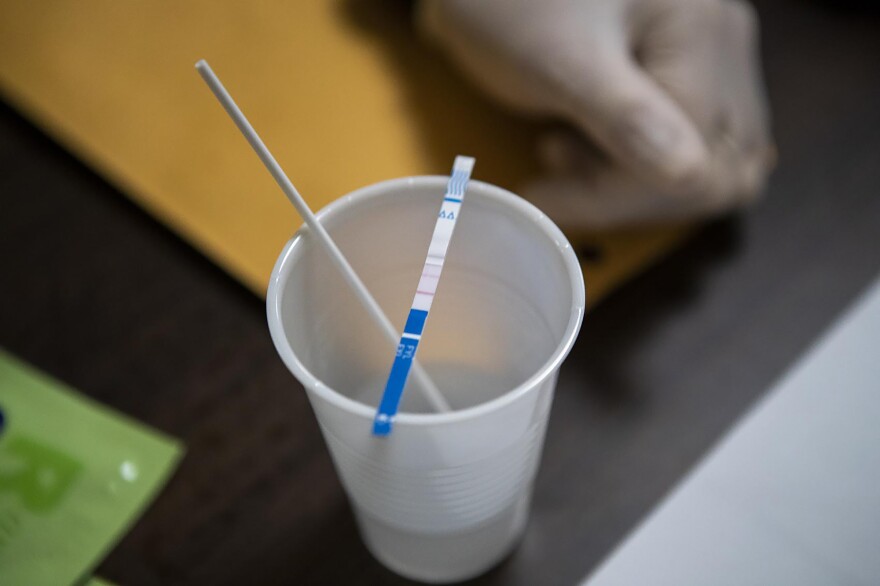 A fentanyl test strip is used to detect fentanyl in a drug sample. Such test strips cost about $1 apiece.