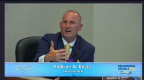 Hillsborough Superintendent Addison Davis gestures with his hand while speaking at a school board meeting