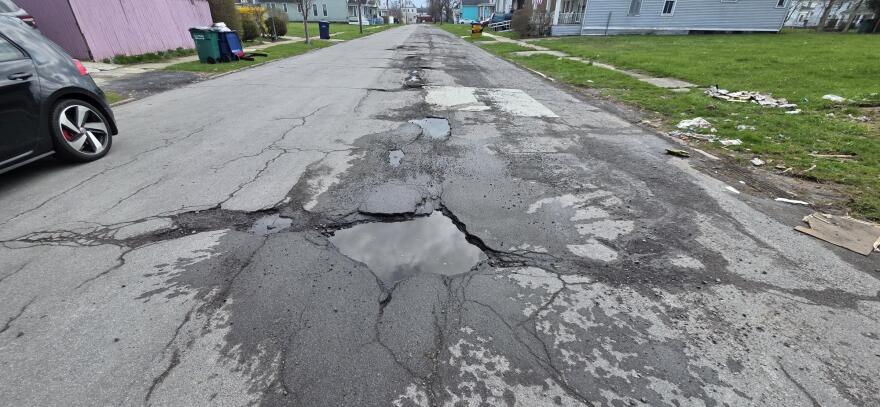 Many Buffalo streets like Goodyear Avenue (pictured) are riddled with potholes and temporary cold patch fixes.