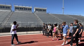 3-time Olympic gold medalist Lashawn Merritt, left, gives advice to Yuma high school track athletes during a clinic at Gila Ridge High School in Yuma on Saturday, Feb. 21, 2026.