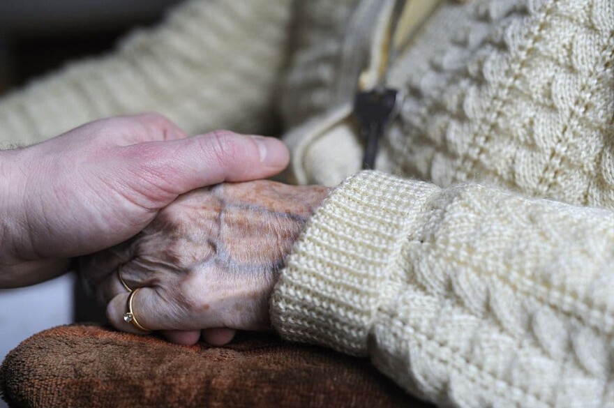 A woman, suffering from Alzheimer's desease, holds the hand of a relative on March 18, 2011 in a retirement house in Angervilliers, eastern France.  (Sebastien Bozon/AFP via Getty Images)