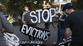 In this Oct. 14, 2020, file photo, housing activists erect a sign in Swampscott, Mass. A federal freeze on most evictions is set to expire soon. The moratorium, put in place by the Centers for Disease Control and Prevention in September, was the only tool keeping millions of tenants in their homes.