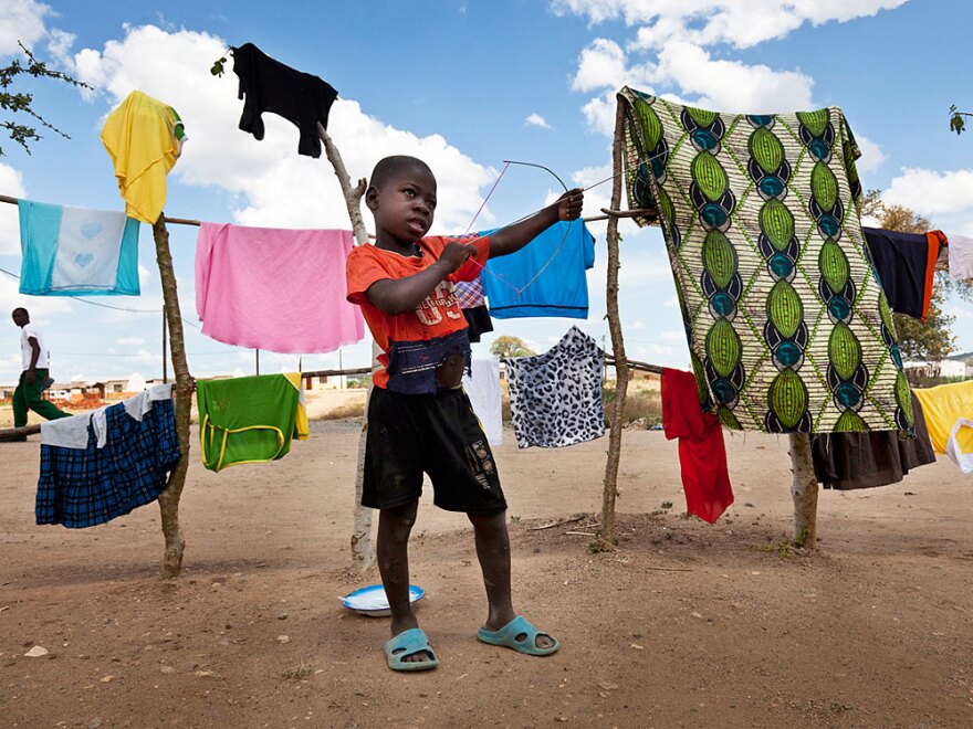 A young child plays at the 25 de Setembro settlement; the Vale company has relocated more than 5,000 people, who lived on the land Vale is now developing for coal mining.