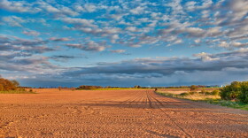 Over nearly two centuries, cultivated fields have lost topsoil, creating the elevation difference between farm and prairie lands.
