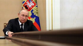 Russian President Vladimir Putin chairs a meeting with members of the Russian government via teleconference in Moscow.