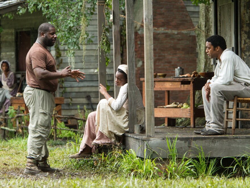 Director Steve McQueen (left) works with actors on the set of <em>12 Years A Slave</em>. The film was shot on a Louisiana plantation that sits next door to where Solomon Northup spent his years as a slave.