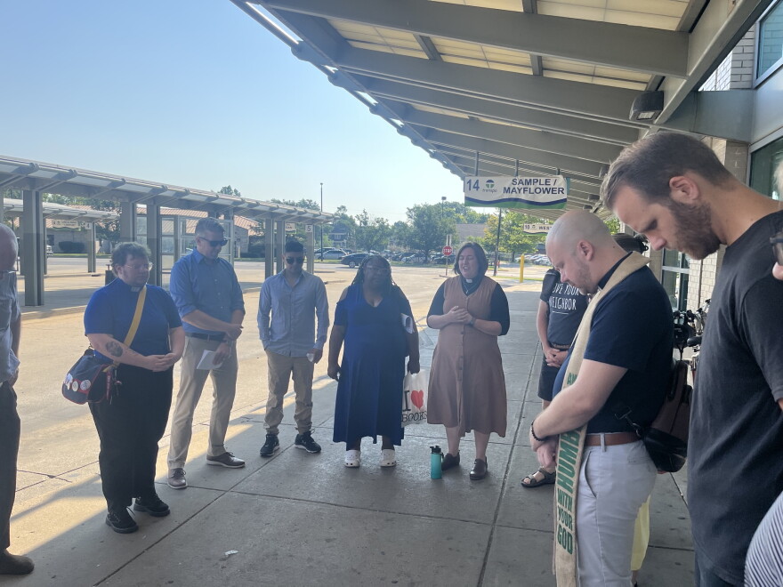 Members of We Make Indiana say a prayer at the Transpo transfer station downtown South Bend on Thursday, as part of their press conference urging Microsoft to pay into a community fund as they build their Granger data center.