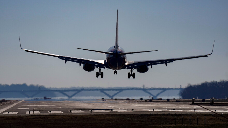A plane lands on a runway.