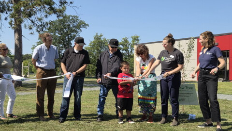 Representatives of the Red Lake Tribal Council, Endazhi-Nitaawiging Charter School and Trust for Public Land cut the ribbon for a new natural playground during a ceremony on Aug. 25, 2026.