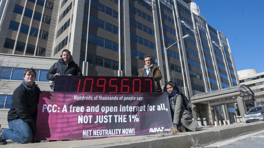 Members of global advocacy group Avaaz stand next to a digital counter showing the number of petition signatures calling for net neutrality outside the Federal Communication Commission in Washington in January. Avaaz joined other groups to deliver more than a million signatures for a free and open Internet to the FCC.