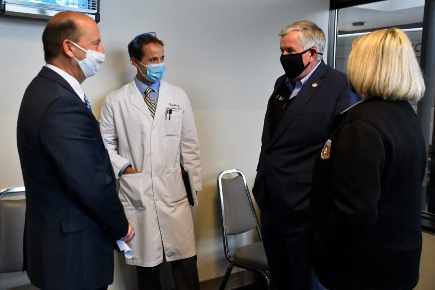 CoxHealth President and CEO Steve Edwards, left, and Dr. Robin Trotman, center, speak with Gov. Mike Parson at Cox Medical Center in Springfield on Oct. 23, 2020.