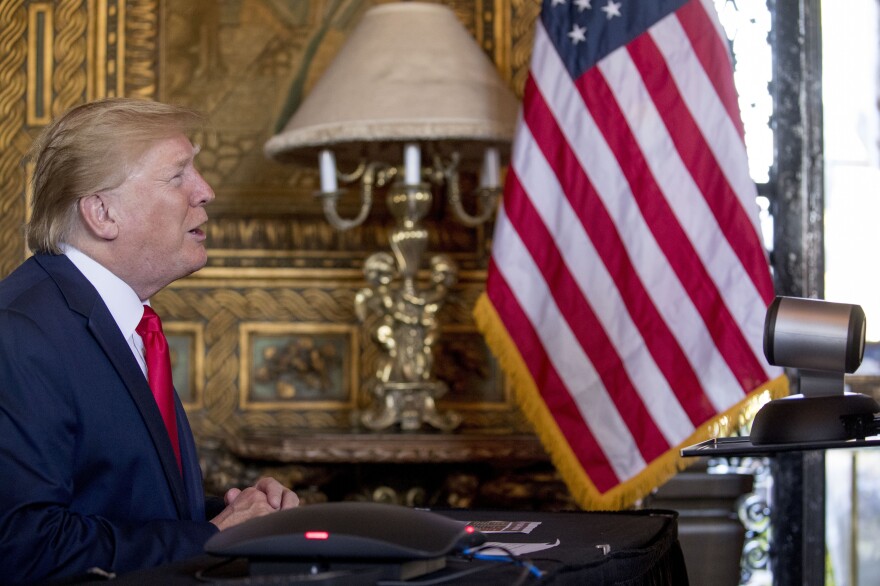 During a Christmas Eve video teleconference, President Trump speaks with members of the military from his Mar-a-Lago estate in Palm Beach, Fla.