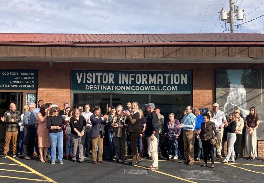 Community members celebrate at a ribbon-cutting outside the new Destination McDowell Visitor Center Thursday, Nov. 20, 2025.