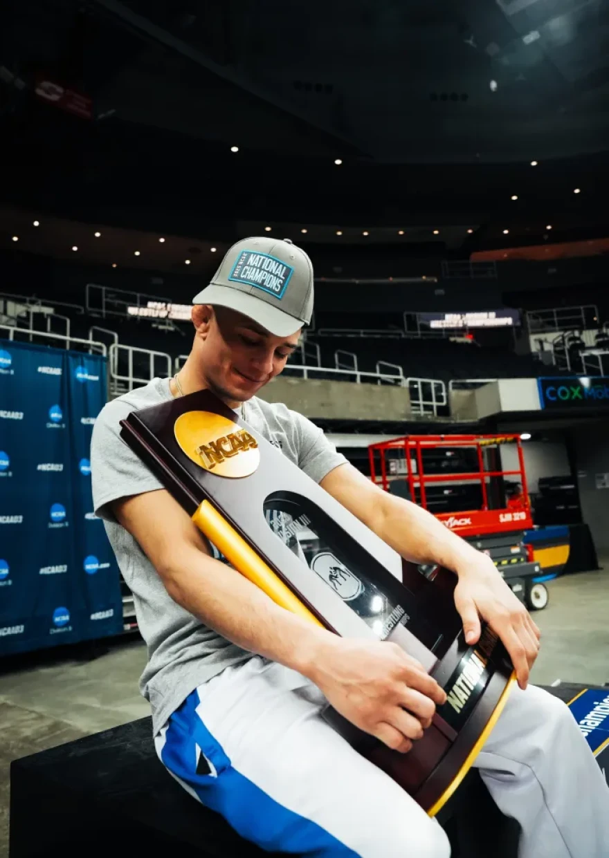 JWU All-America Hayden Brown clutches the DIII championship trophy.